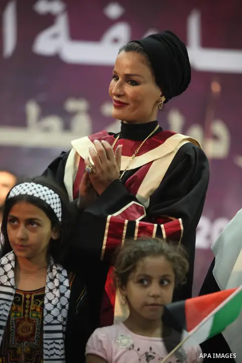 Qatar's First Lady Sheikha Mozah bint Nasser al-Missned stands with the wife of Gaza's prime minister Ismail Haniyah surrounding with Palestinian children at the Islamic University in Gaza city on October 23, 2012. The E...
