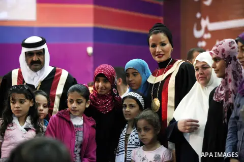 Qatar's First Lady Sheikha Mozah bint Nasser al-Missned stands with the wife of Gaza's prime minister Ismail Haniyah surrounding with Palestinian children at the Islamic University in Gaza city on October 23, 2012. The E...