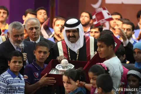 Qatari Emir Sheikh Hamad bin Khalifa al-Thani and Palestinian prime minister in Gaza strip, Ismail Haniyah attend a celebration at the Islamic University in Gaza city on October 23, 2012. The Emir of Qatar entered the Ga...