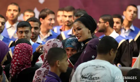 Qatar's First Lady Sheikha Mozah bint Nasser al-Missned stands with the wife of Gaza's prime minister Ismail Haniyah surrounding with Palestinian children at the Islamic University in Gaza city on October 23, 2012. The E...