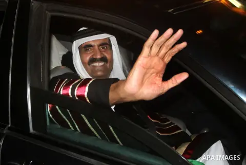 Qatari Emir Sheikh Hamad bin Khalifa al-Thani and his wife Sheikha Mozah bint Nasser al-Missned wave to the crowds as Gaza's Hamas prime minister Ismail Haniya drives in a car in Gaza City on October 23, 2012. The Emir o...