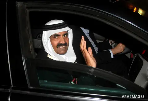 Qatari Emir Sheikh Hamad bin Khalifa al-Thani and his wife Sheikha Mozah bint Nasser al-Missned wave to the crowds as Gaza's Hamas prime minister Ismail Haniya drives in a car in Gaza City on October 23, 2012. The Emir o...