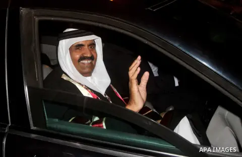 Qatari Emir Sheikh Hamad bin Khalifa al-Thani and his wife Sheikha Mozah bint Nasser al-Missned wave to the crowds as Gaza's Hamas prime minister Ismail Haniya drives in a car in Gaza City on October 23, 2012. The Emir o...