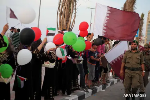 Palestinians hold balloons in the colour of the national flag waits for the arrival of Emir of Qatar Sheik Hamad bin Khalifa al-Thani in Gaza City on October 23, 2012. Qatar's emir was warmly welcomed on a landmark tour...
