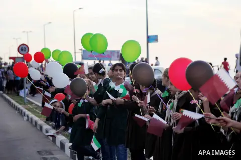 Palestinians hold balloons in the colour of the national flag waits for the arrival of Emir of Qatar Sheik Hamad bin Khalifa al-Thani in Gaza City on October 23, 2012. Qatar's emir was warmly welcomed on a landmark tour...