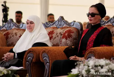 Qatar's First Lady Sheikha Mozah bint Nasser al-Missned sits with the wife of Gaza's prime minister Ismail Haniyah attend a cornerstone laying ceremony for Hamad, a new residential neighbourhood in Khan Younis in the sou...