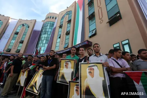 Palestinians gather during the arrival of Emir of Qatar Sheik Hamad bin Khalifa al-Thani at the Islamic University in Gaza city on October 23, 2012. The Emir of Qatar entered the Gaza Strip on Tuesday for a visit that br...