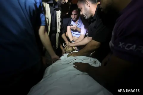 Palestinians wheel the body of a militant at a hospital, following an Israeli air strike in the northern Gaza Strip October 23, 2012. An Israeli air strike killed one Palestinian militant and critically wounded another i...