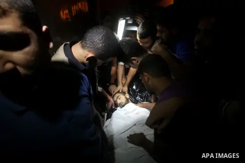Palestinians wheel the body of a militant at a hospital, following an Israeli air strike in the northern Gaza Strip October 23, 2012. An Israeli air strike killed one Palestinian militant and critically wounded another i...