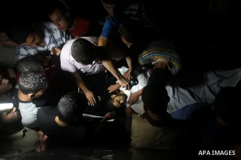 Palestinians wheel the body of a militant at a hospital, following an Israeli air strike in the northern Gaza Strip October 23, 2012. An Israeli air strike killed one Palestinian militant and critically wounded another i...