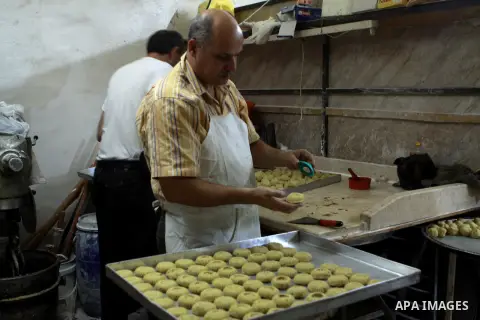 A Palestinian worker makes traditional date-filled cookies in preparation for the of Eid al-Adha, in the West Bank city of Nablus, on October 23, 2012. Muslims around the world prepare to celebrate Eid Al-Adha, which acc...