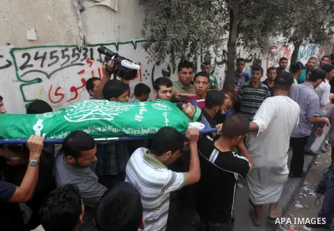 Palestinian mourners carry the body of of Hamas gunman Ismail al-Tille during his funeral in Beit Lahiya in the northern Gaza Strip October 24, 2012. Israel killed a Hamas gunman in its second round of air strikes in as...