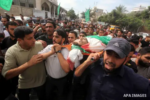 Palestinian mourners carry the body of Luay Abu Jarad during his funeral in Beit Lahiya in the northern Gaza Strip October 24, 2012. Israel killed a Hamas gunman in its second round of air strikes in as many days on the...