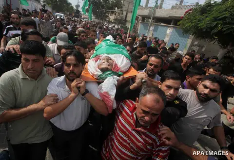 Palestinian mourners carry the body of Luay Abu Jarad during his funeral in Beit Lahiya in the northern Gaza Strip October 24, 2012. Israel killed a Hamas gunman in its second round of air strikes in as many days on the...