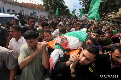 Palestinian mourners carry the body of Luay Abu Jarad during his funeral in Beit Lahiya in the northern Gaza Strip October 24, 2012. Israel killed a Hamas gunman in its second round of air strikes in as many days on the...