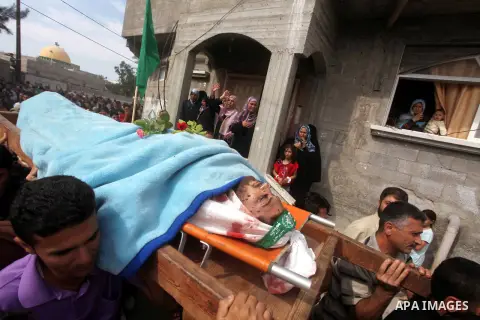 Palestinian mourners carry the body of Luay Abu Jarad during his funeral in Beit Lahiya in the northern Gaza Strip October 24, 2012. Israel killed a Hamas gunman in its second round of air strikes in as many days on the...