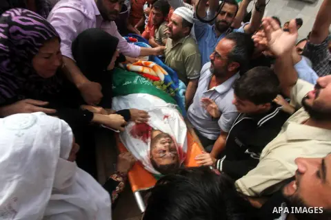 Palestinians surround the body of Hamas gunman Loay Abu Jarad during his funeral in Beit Lahiya in the northern Gaza Strip October 24, 2012. Israel killed a Hamas gunman in its second round of air strikes in as many days...