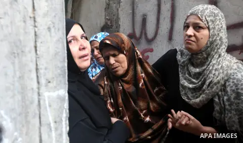 The mother of Palestinian Hamas militant Ismail al-Tili mourns during his funeral in Beit Lahia, northern Gaza Strip, on October 24, 2012. Palestinians fired more than 40 rockets from the Gaza Strip into Israel injuring...
