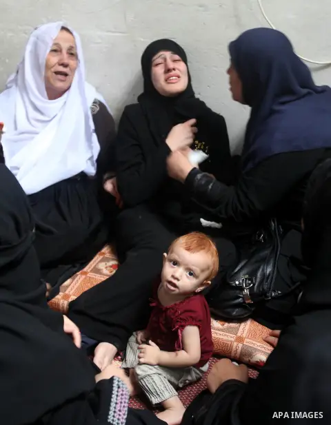 Palestinian relatives of Hamas militant Ismail al-Tili mourns during his funeral in Beit Lahia, northern Gaza Strip, on October 24, 2012. Palestinians fired more than 40 rockets from the Gaza Strip into Israel injuring t...