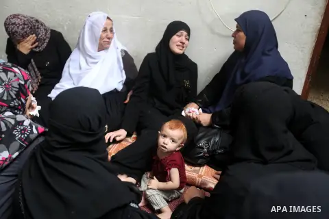Palestinian relatives of Hamas militant Ismail al-Tili mourns during his funeral in Beit Lahia, northern Gaza Strip, on October 24, 2012. Palestinians fired more than 40 rockets from the Gaza Strip into Israel injuring t...