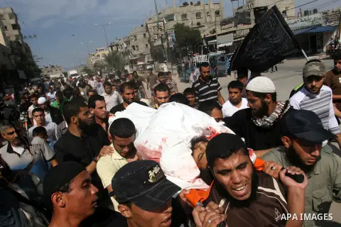 Palestinian mourners carry the body of militant Mohamed al-Shikh during his funeral in Rafah, southern Gaza Strip, on October 24, 2012. Palestinians fired more than 40 rockets from the Gaza Strip into Israel injuring thr...