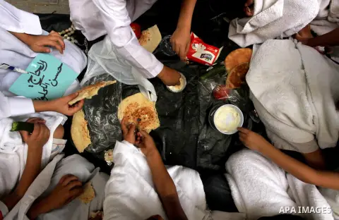 Palestinian children eat as part of training children how to perform Hajj pilgrimage, in Gaza City, on October 24, 2012. Muslims from around the world flood Saudi city of Mecca to perform the annual Hajj pilgrimage, whic...