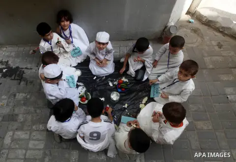 Palestinian children eat as part of training children how to perform Hajj pilgrimage, in Gaza City, on October 24, 2012. Muslims from around the world flood Saudi city of Mecca to perform the annual Hajj pilgrimage, whic...