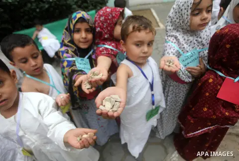 Palestinian children gather for Jamarat (Stoning the Devil) as part of training children how to perform Hajj pilgrimage, in Gaza City, on October 24, 2012. Muslims from around the world flood Saudi city of Mecca to perfo...