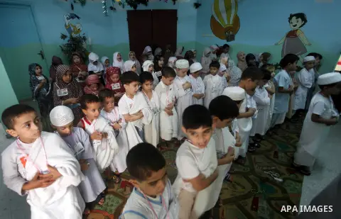 Palestinian children pray as part of training children how to perform Hajj pilgrimage, in Gaza City, on October 24, 2012. Muslims from around the world flood Saudi city of Mecca to perform the annual Hajj pilgrimage, whi...