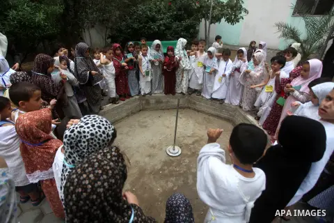 Palestinian children gather for Jamarat (Stoning the Devil) as part of training children how to perform Hajj pilgrimage, in Gaza City, on October 24, 2012. Muslims from around the world flood Saudi city of Mecca to perfo...