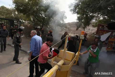 Palestinian, Israeli and foreign activists scuffle with Israeli troops after storming a supermarket in protest against Jewish settlements in a call on Palestinian shoppers to boycott settlement products and businesses in...