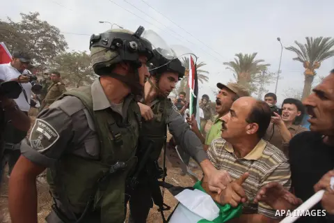 Palestinian, Israeli and foreign activists scuffle with Israeli troops after storming a supermarket in protest against Jewish settlements in a call on Palestinian shoppers to boycott settlement products and businesses in...