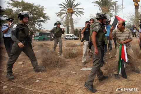 Palestinian, Israeli and foreign activists scuffle with Israeli troops after storming a supermarket in protest against Jewish settlements in a call on Palestinian shoppers to boycott settlement products and businesses in...