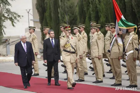 Palestinian President Mahmoud Abbas, Left, and Bulgarian President Rosen Plevneliev review an honor guard prior to their meeting in the West Bank city of Ramallah, Oct. 24, 2012. Photo by Issam Rimawi