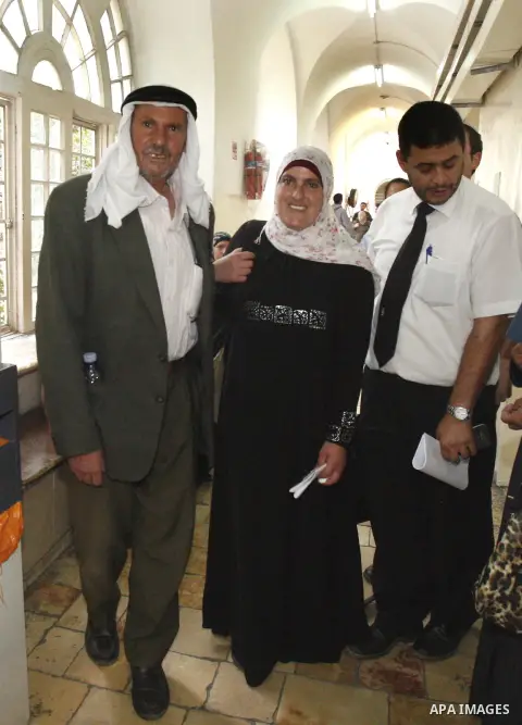 A Palestinian woman stands with her family after an Israeli court decide to release her following her participation in a rally in front of al-Aqsa mosque this morning, in Jerusalem, Oct. 24, 2012. Photo by Mahfouz Abu Tu...