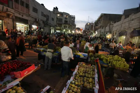 Palestinians shop at a market during preparations for the Eid al-Adha, in the West Bank city of Ramallah, on October 24, 2012. Muslims around the world prepare to celebrate Eid Al-Adha, which according to the lunar calen...