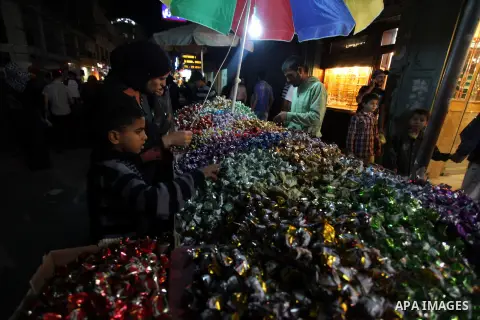Palestinians shop at a market during preparations for the Eid al-Adha, in the West Bank city of Ramallah, on October 24, 2012. Muslims around the world prepare to celebrate Eid Al-Adha, which according to the lunar calen...