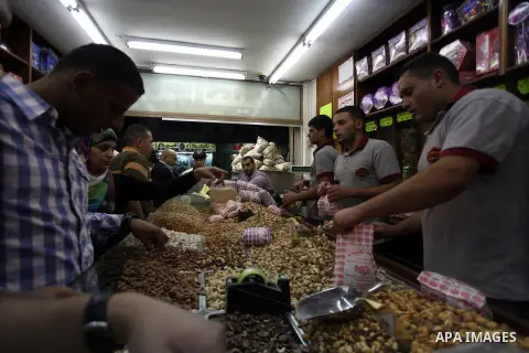 Palestinians shop at a market during preparations for the Eid al-Adha, in the West Bank city of Ramallah, on October 24, 2012. Muslims around the world prepare to celebrate Eid Al-Adha, which according to the lunar calen...