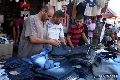 Palestinians buy clothes in Gaza city, on October 25, 2012, in preparation for Eid al-Adha. Millions of Muslims around the world celebrate Eid al-Adha or "Feast of the Sacrifice", which marks the end of the annual hajj o...