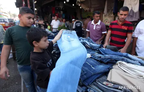 Palestinians buy clothes in Gaza city, on October 25, 2012, in preparation for Eid al-Adha. Millions of Muslims around the world celebrate Eid al-Adha or "Feast of the Sacrifice", which marks the end of the annual hajj o...