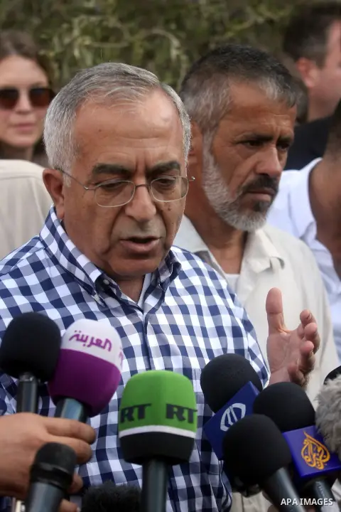 Palestinian Prime Minister Salam Fayyad speaks during visit olive farms in the West Bank village of Ras Karkar near Ramallah, on October 25, 2012. Photo by Issam Rimawi