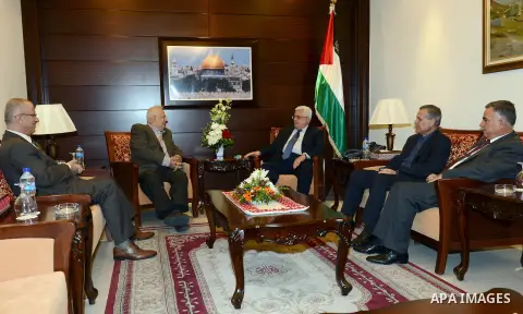 Palestinian president Mahmoud Abbas (R) meets with the Central Election Commission at the presidential headquarters in the West Bank city of Ramallah on October 25, 2012. Photo by Thaer Ganaim