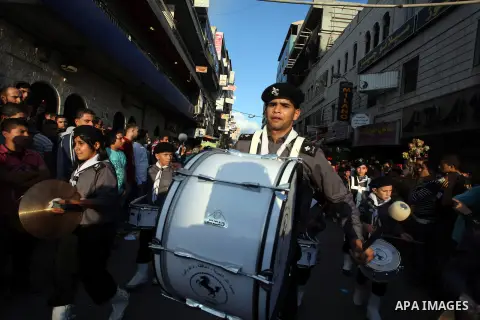 Palestinian boy scouts march through streets during a rally in celebration the Muslim festival of Eid al-Adha, in the West Bank city of Ramallah, on October 25, 2012. Muslims around the world prepare to celebrate Eid Al-...