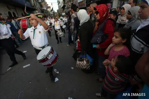 Palestinian boy scouts march through streets during a rally in celebration the Muslim festival of Eid al-Adha, in the West Bank city of Ramallah, on October 25, 2012. Muslims around the world prepare to celebrate Eid Al-...