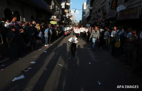Palestinian boy scouts march through streets during a rally in celebration the Muslim festival of Eid al-Adha, in the West Bank city of Ramallah, on October 25, 2012. Muslims around the world prepare to celebrate Eid Al-...