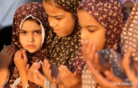 Palestinians attend Eid Al-Adha prayers on the first day of the Muslim holiday, at the Palestine Stadium in Gaza City, on October 26, 2012. Muslims around the world celebrate Eid al-Adha to mark the end of the haj by sla...