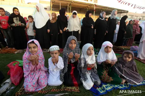 Palestinians attend Eid Al-Adha prayers on the first day of the Muslim holiday, at the Palestine Stadium in Gaza City, on October 26, 2012. Muslims around the world celebrate Eid al-Adha to mark the end of the haj by sla...