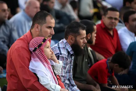 Palestinians attend Eid Al-Adha prayers on the first day of the Muslim holiday, at the Palestine Stadium in Gaza City, on October 26, 2012. Muslims around the world celebrate Eid al-Adha to mark the end of the haj by sla...