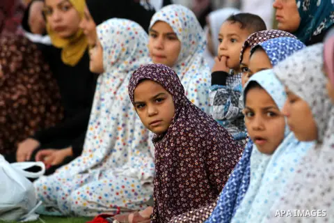 Palestinians attend Eid Al-Adha prayers on the first day of the Muslim holiday, at the Palestine Stadium in Gaza City, on October 26, 2012. Muslims around the world celebrate Eid al-Adha to mark the end of the haj by sla...