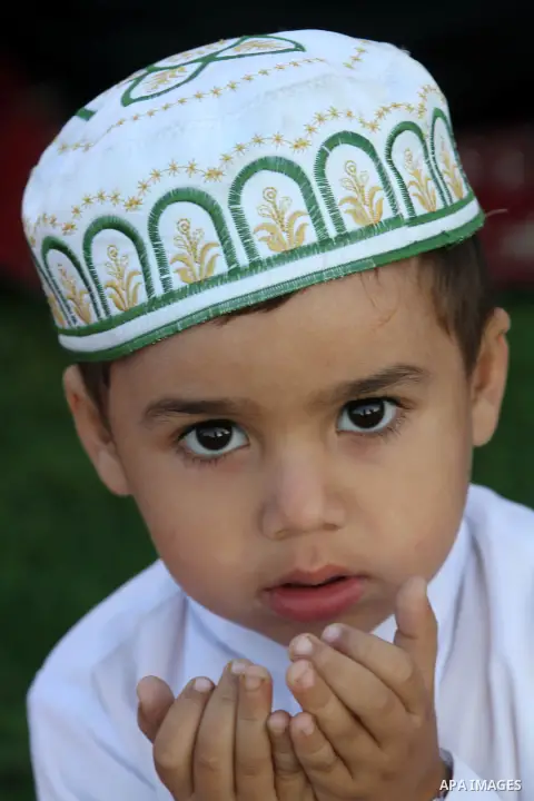 Palestinians attend Eid Al-Adha prayers on the first day of the Muslim holiday, at the Palestine Stadium in Gaza City, on October 26, 2012. Muslims around the world celebrate Eid al-Adha to mark the end of the haj by sla...